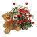 Teddy Bear & Roses. A charming teddy bear and and arrangement of tender red roses with greens in basket.. Novosibirsk